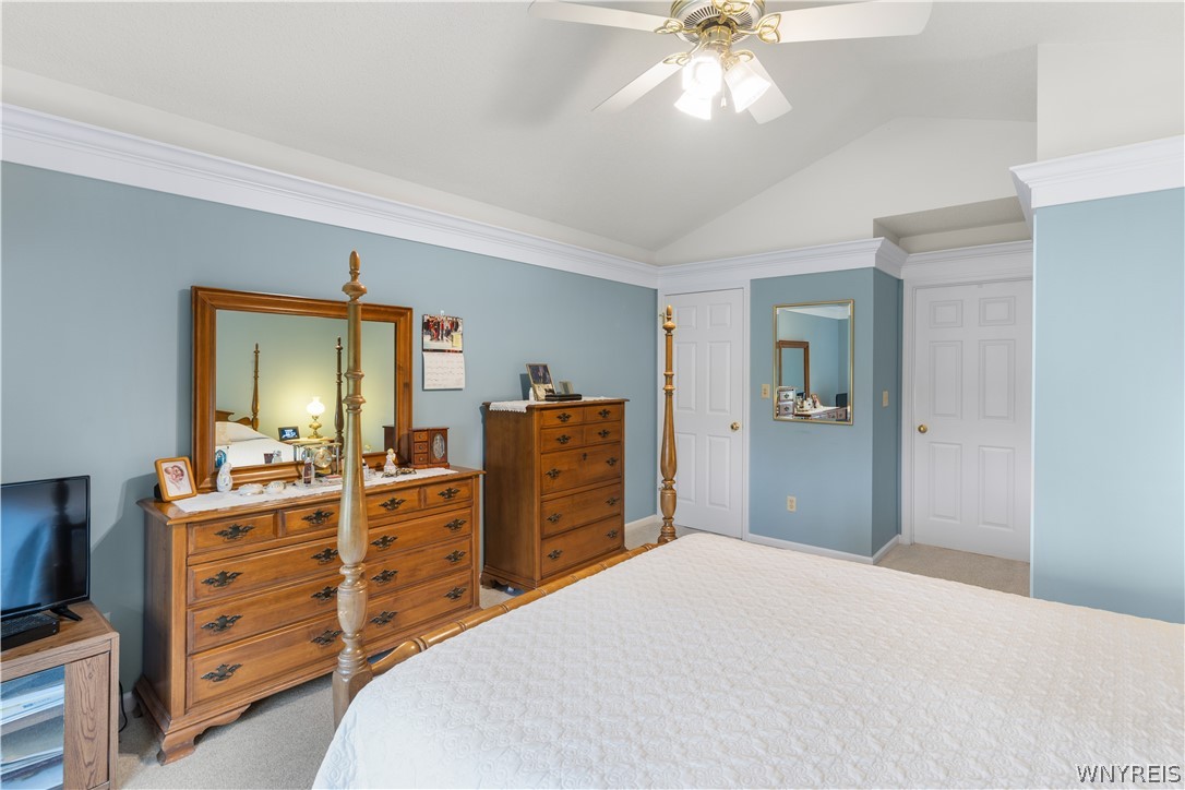 2850 Amsdell Road, Unit 34 Hamburg, NY 14075 - Photo 20 of 33 Vaulted ceilings and elegant crown molding elevate this serene bedroom space.