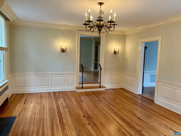 wooden floor in an empty room with a mirror