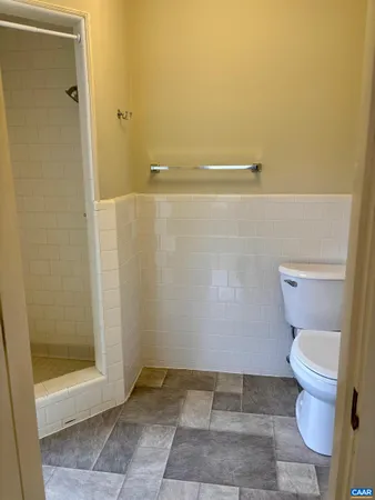 a bathroom with a toilet and a shower