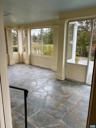 an empty room with large windows