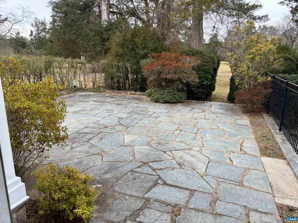 a view of a pathway with a wrought fence