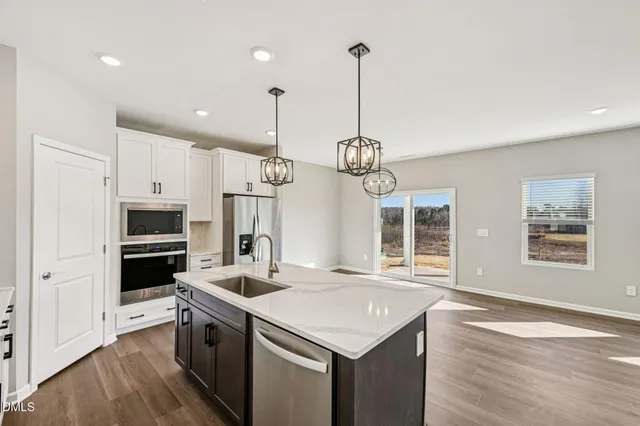 a kitchen with a center island and stainless steel appliances
