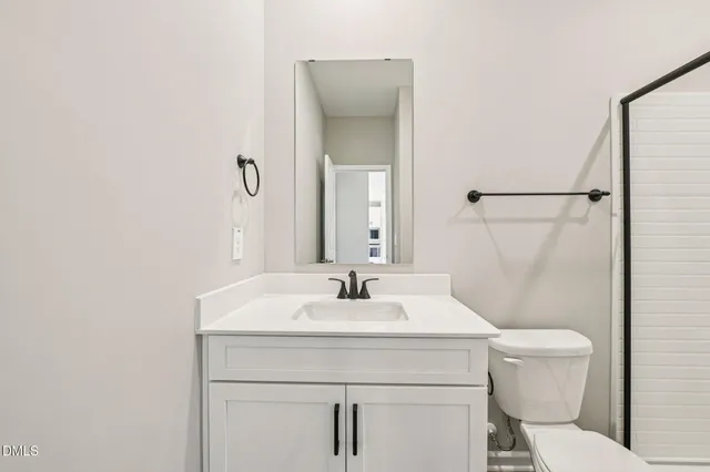 a bathroom with a sink toilet and mirror