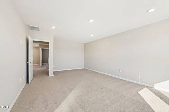 an empty room with a empty space and windows