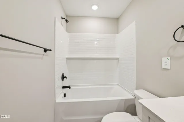 a bathroom with a bathtub a toilet and a shower