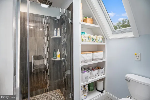 a bathroom with a glass shower door