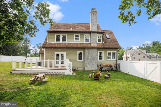 a front view of a house with a garden and yard