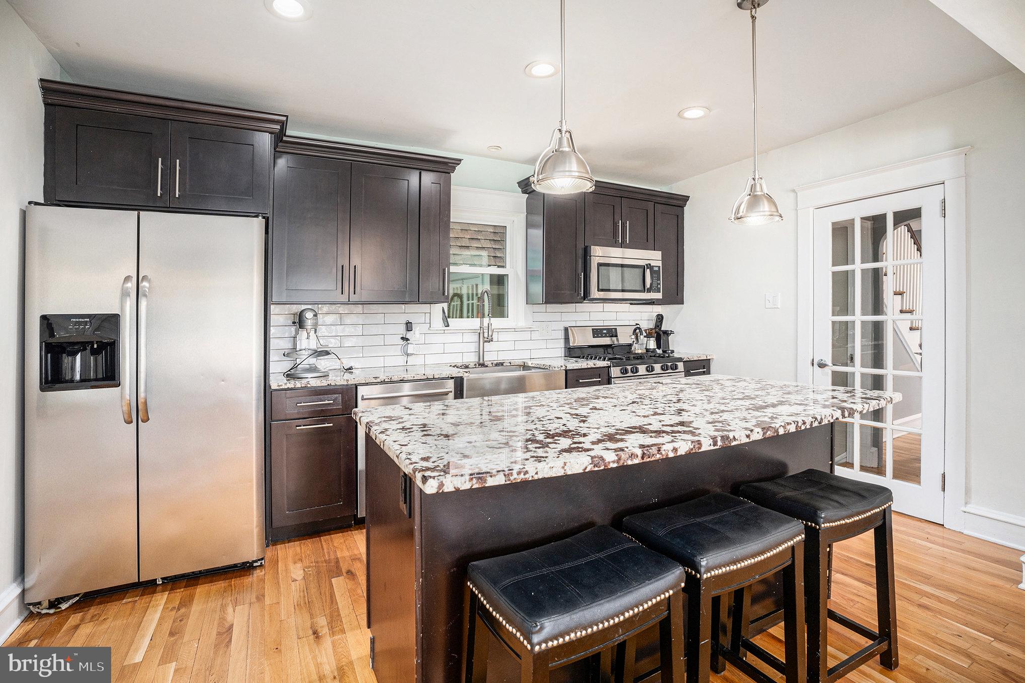 7238 Hollywood Road Fort Washington, PA 19034 - Photo 9 of 27 a kitchen with granite countertop kitchen island stainless steel appliances a sink and refrigerator
