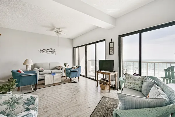 a living room with furniture tv and a large window