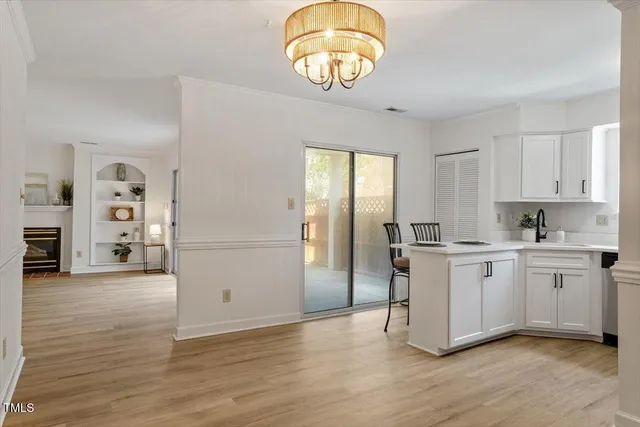 a kitchen with a refrigerator and a stove top oven