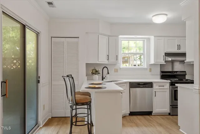 a kitchen with a stove a sink and a refrigerator