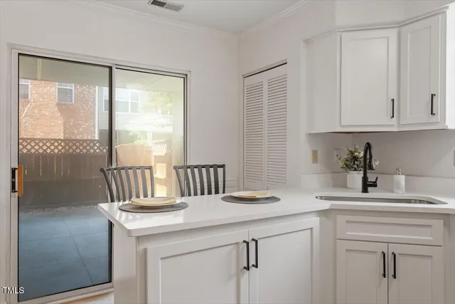 a kitchen with a sink cabinets and a window