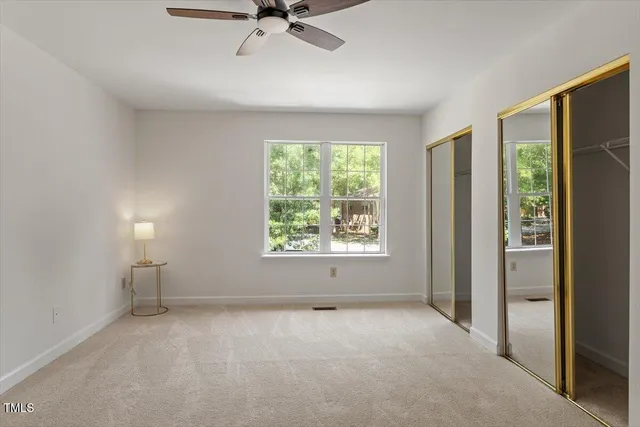 a view of a livingroom with a ceiling fan and window