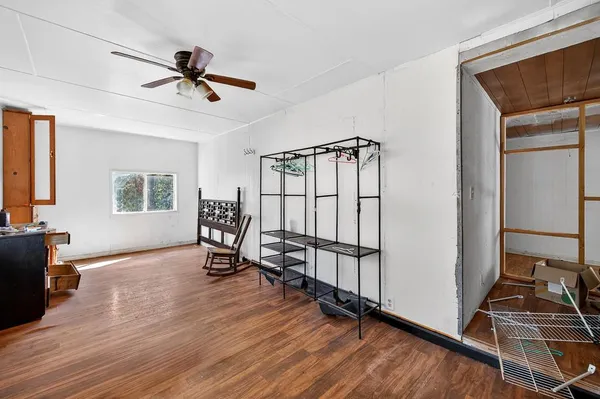 a living room with hard wood floors and a window