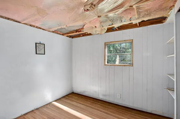 a view of a house with a yard and large tree