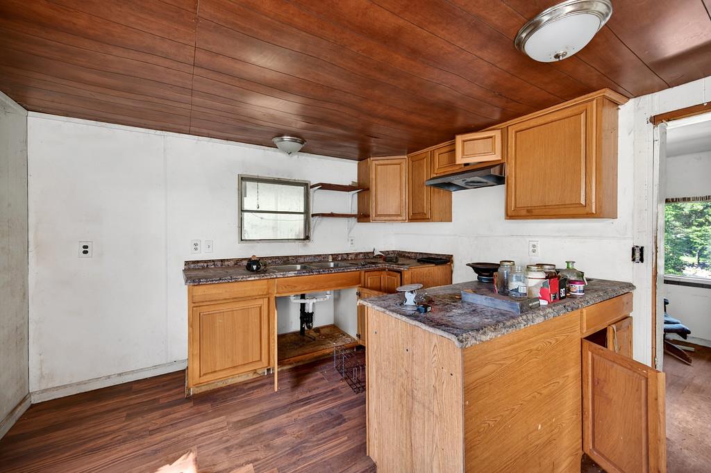 5404 Forbestown Road Forbestown, CA 95941 - Photo 8 of 14 a kitchen with stainless steel appliances granite countertop a sink stove and wooden cabinets