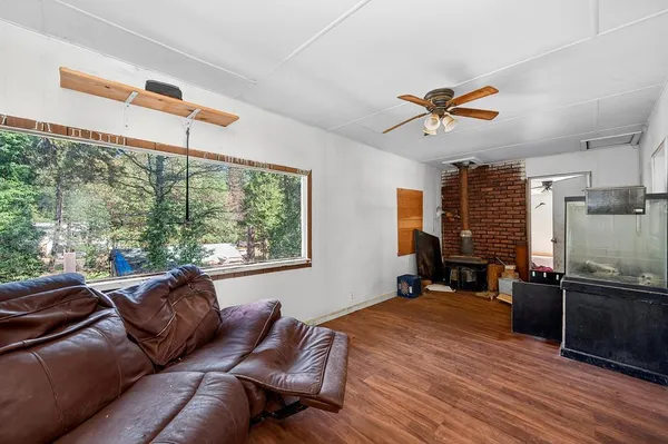 a living room with furniture gym equipment and a window