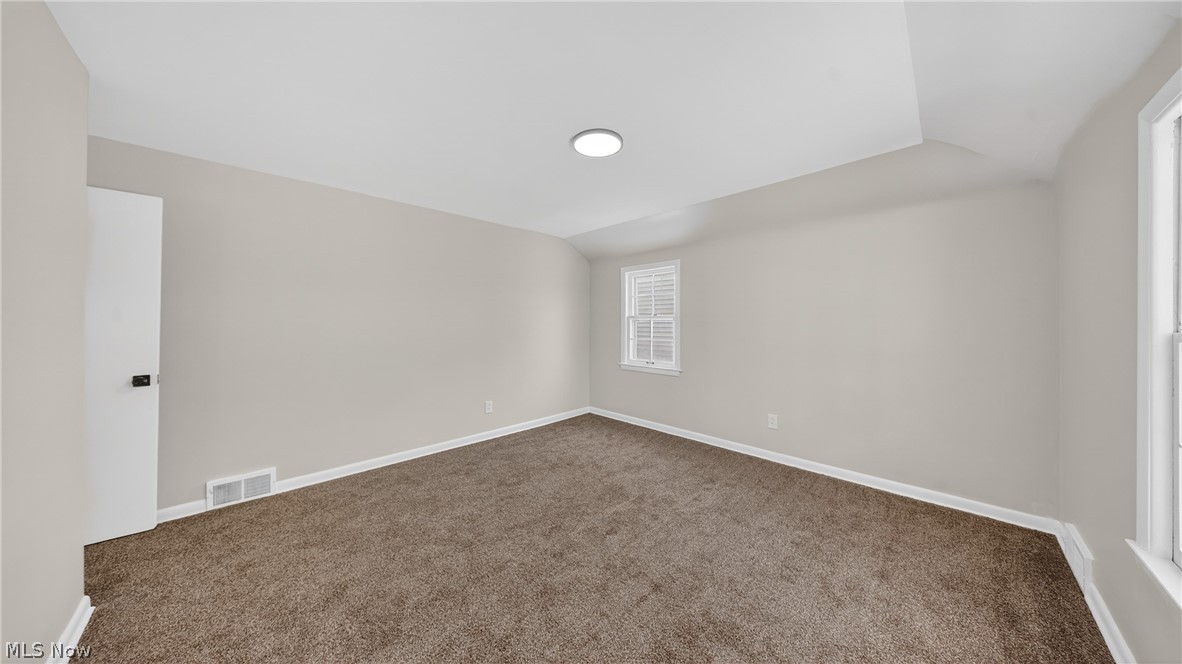 16811 Invermere Avenue Cleveland, OH 44128 - Photo 34 of 47 Carpeted spare room with lofted ceiling and baseboards