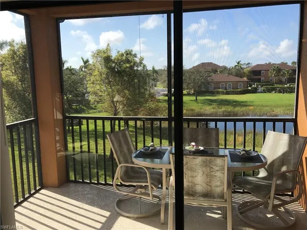 a view of a balcony with chair and wooden floor