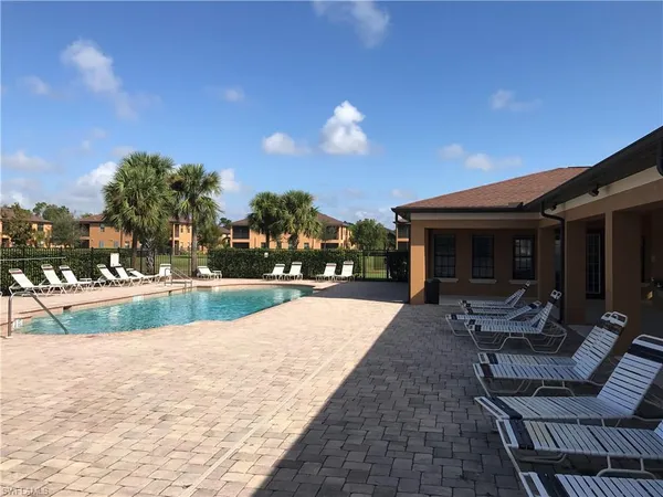 a view of a house with backyard and sitting area