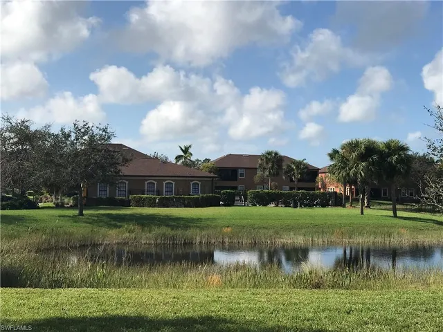 a view of a lake with a yard in front of it