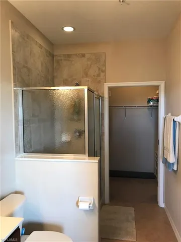 a bathroom with a shower and toilet