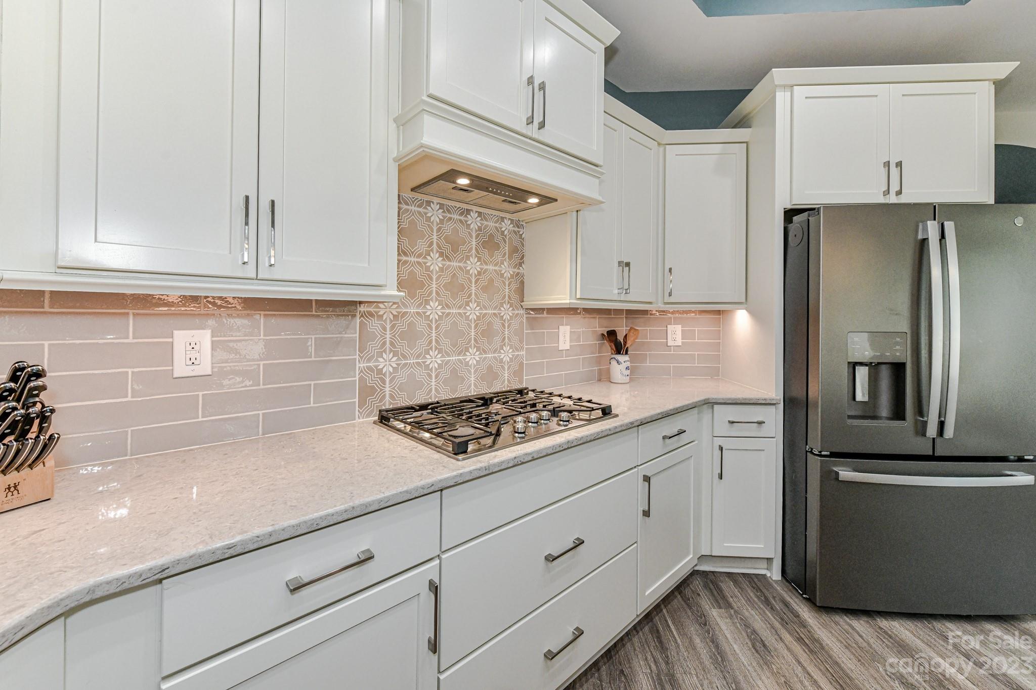 2330 Wesley Landing Road Waxhaw, NC 28173 - Photo 15 of 47 a kitchen with cabinets stainless steel appliances and wooden floor