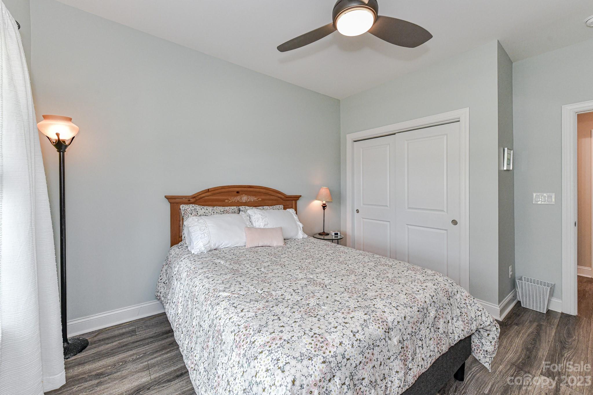 2330 Wesley Landing Road Waxhaw, NC 28173 - Photo 30 of 47 a bedroom with a bed and a chandelier