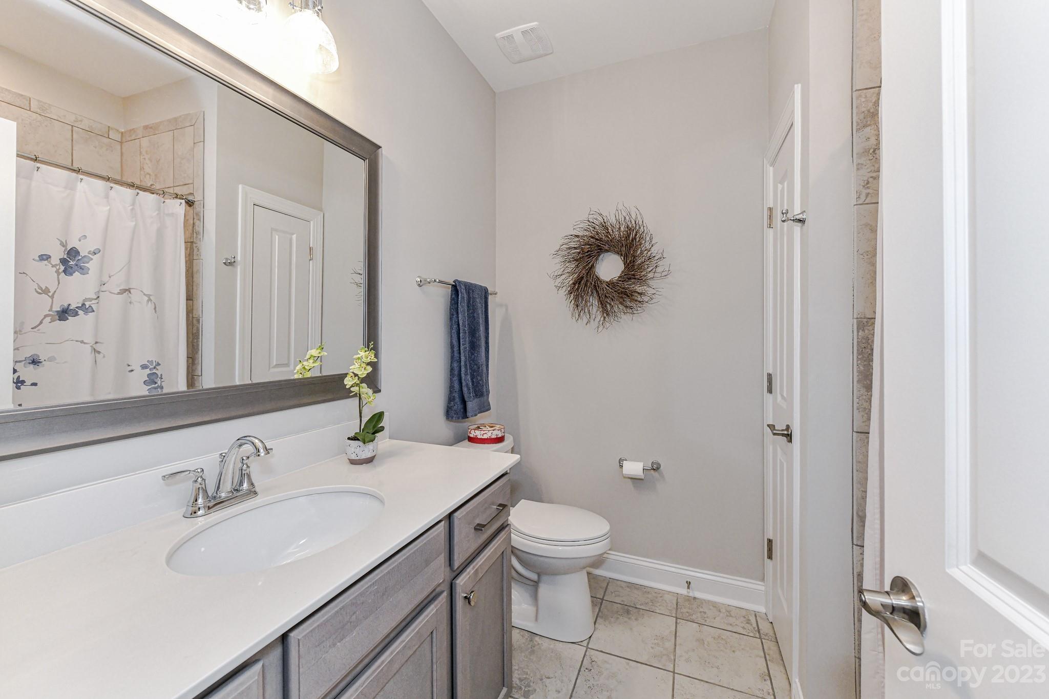 2330 Wesley Landing Road Waxhaw, NC 28173 - Photo 31 of 47 a bathroom with a granite countertop sink toilet and shower