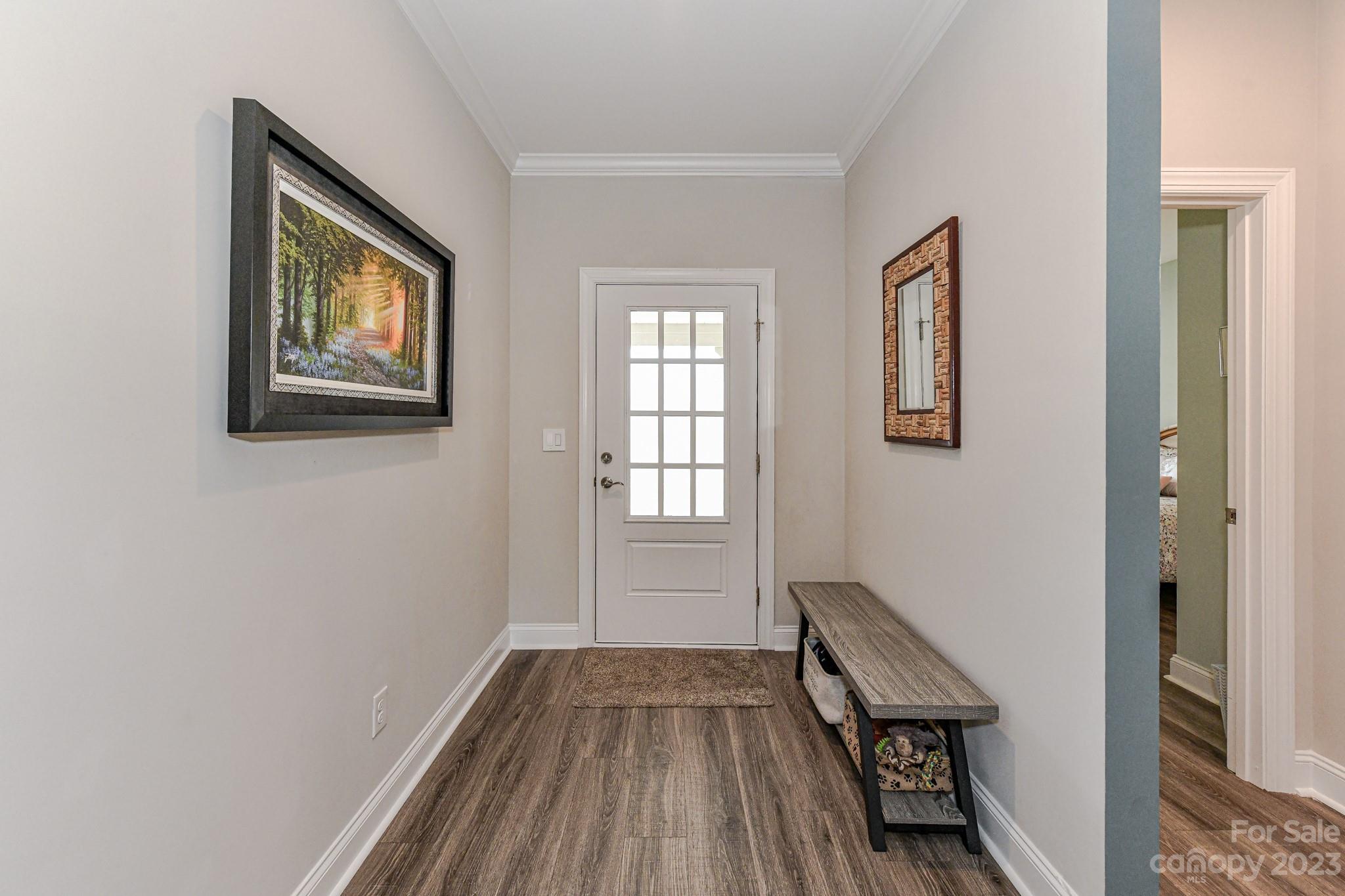 2330 Wesley Landing Road Waxhaw, NC 28173 - Photo 7 of 47 a view of a hallway with wooden floor and a window