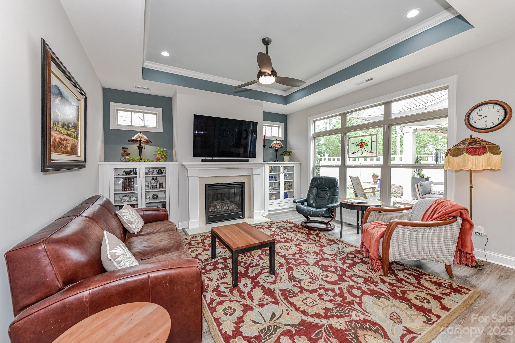 2330 Wesley Landing Road Waxhaw, NC 28173 - Photo 8 of 47 a living room with furniture a fireplace and a flat screen tv