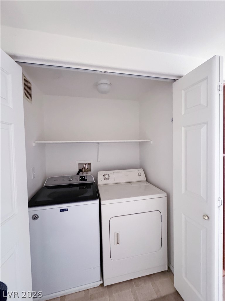 9580 West Reno Avenue, Unit 242 Las Vegas, NV 89148 - Photo 20 of 26 A dedicated closet houses essential laundry appliances, offering practical convenience.