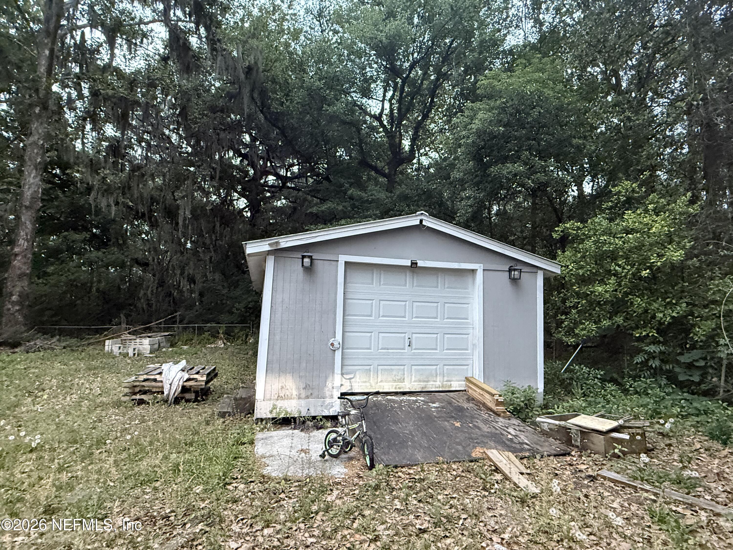 10565 Bessent Road North Jacksonville, FL 32218 - Photo 2 of 16 a view of backyard of house with car parked