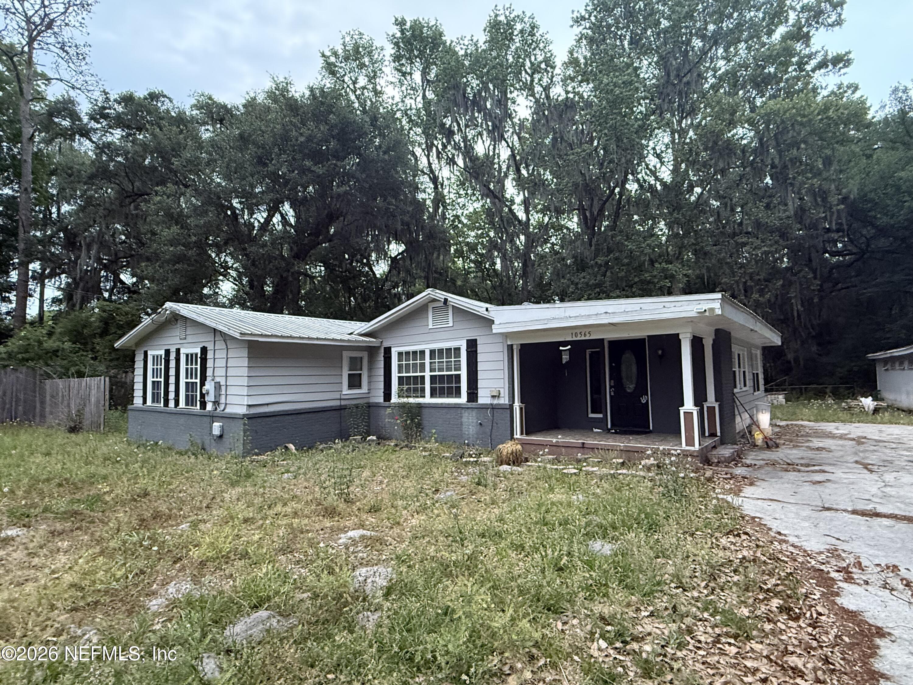 10565 Bessent Road North Jacksonville, FL 32218 - Photo 3 of 16 a house that has a tree in front of it