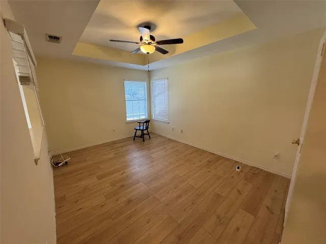 a view of room with a ceiling fan and hardwood floor