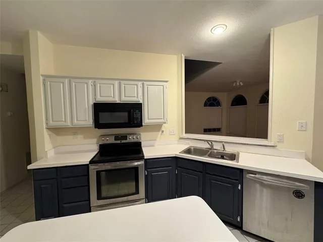 a kitchen with a sink and a stove top oven