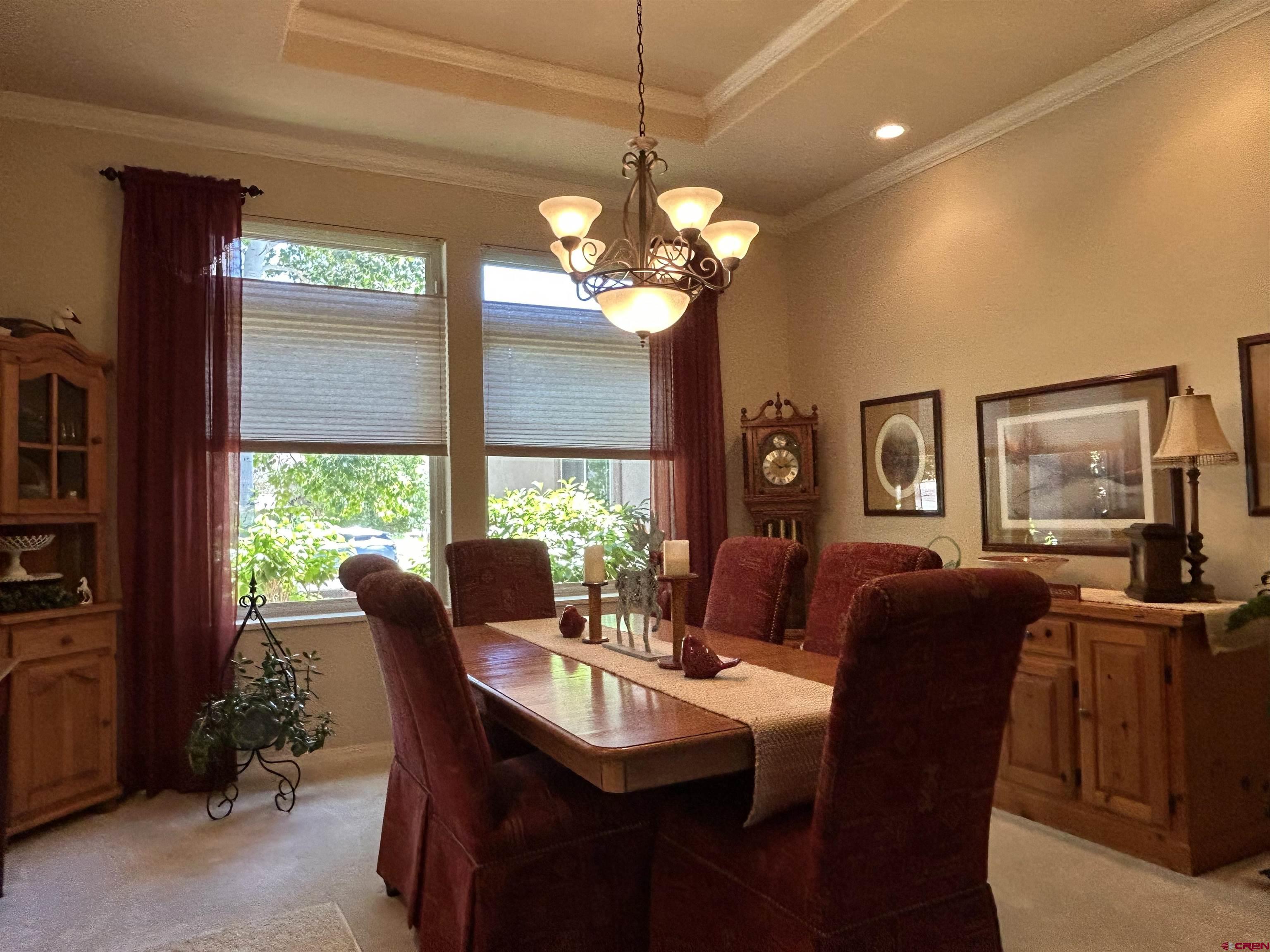 850 Southeast Pinyon Street Cedaredge, CO 81413 - Photo 9 of 45 a dining room with furniture a chandelier and a flat screen tv
