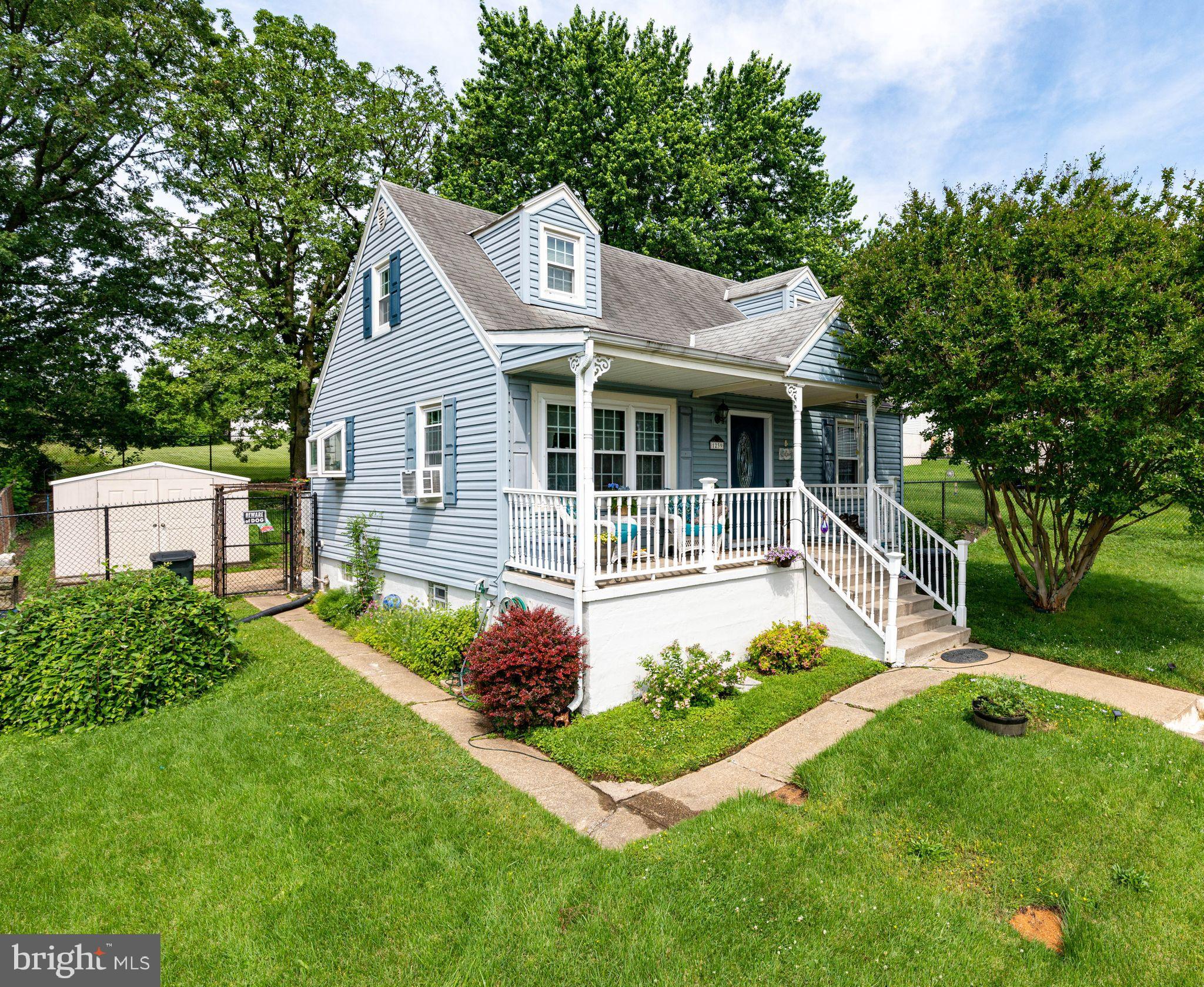 1239 Landover Road Baltimore, MD 21237 - Photo 1 of 13 a front view of a house with a garden and plants