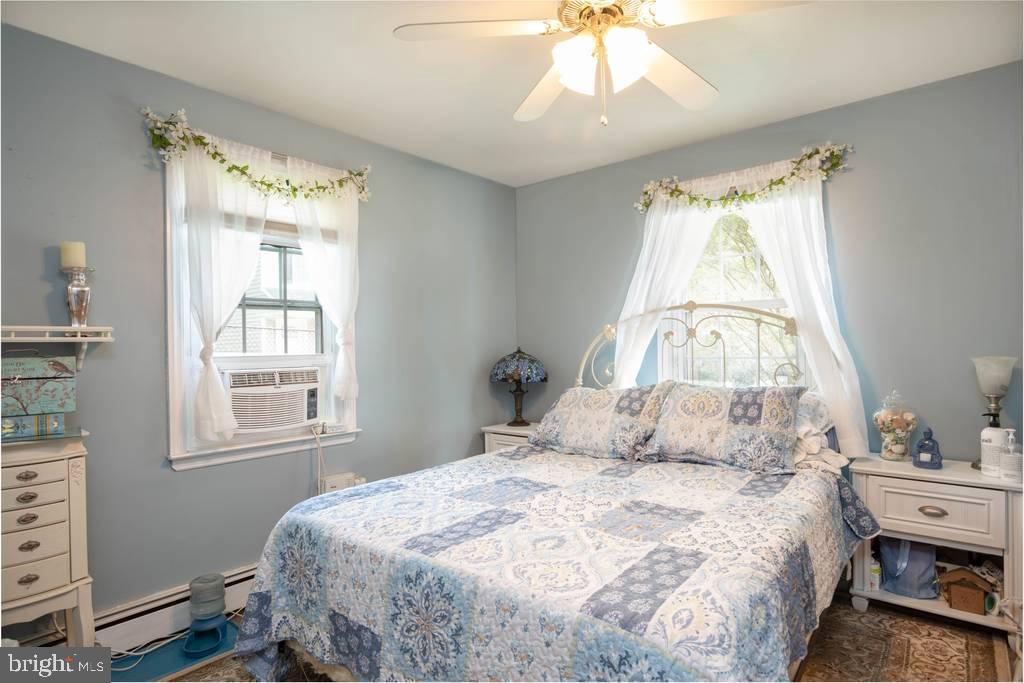 1239 Landover Road Baltimore, MD 21237 - Photo 11 of 13 a bedroom with a bed and a window