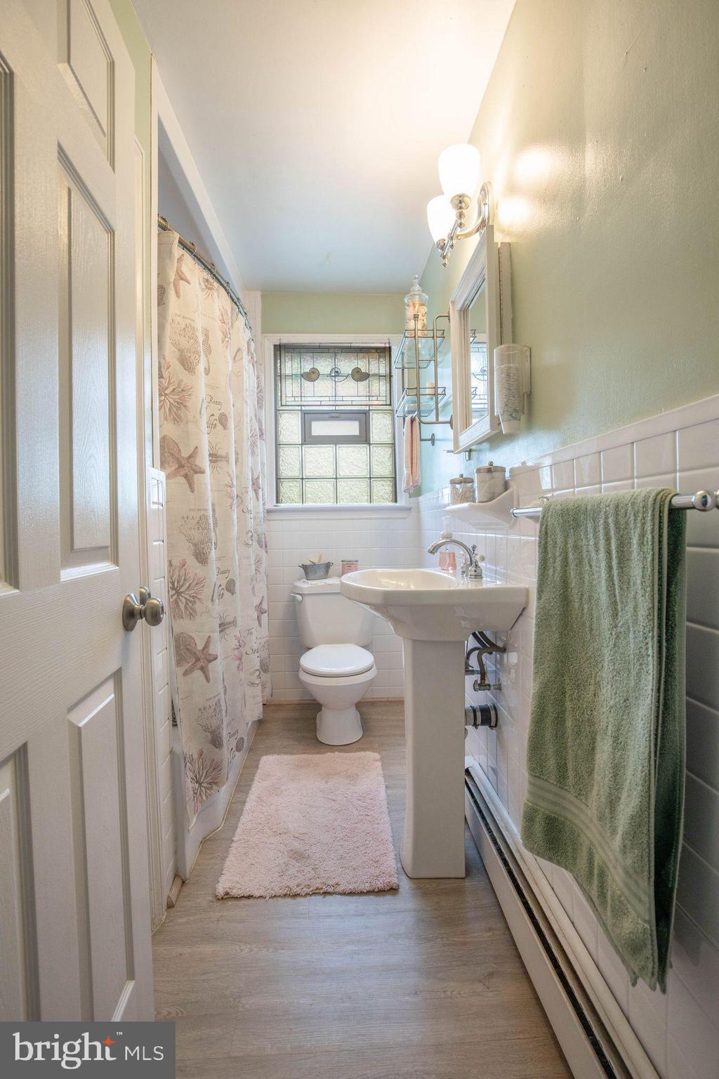 1239 Landover Road Baltimore, MD 21237 - Photo 12 of 13 a bathroom with a sink a toilet and shower