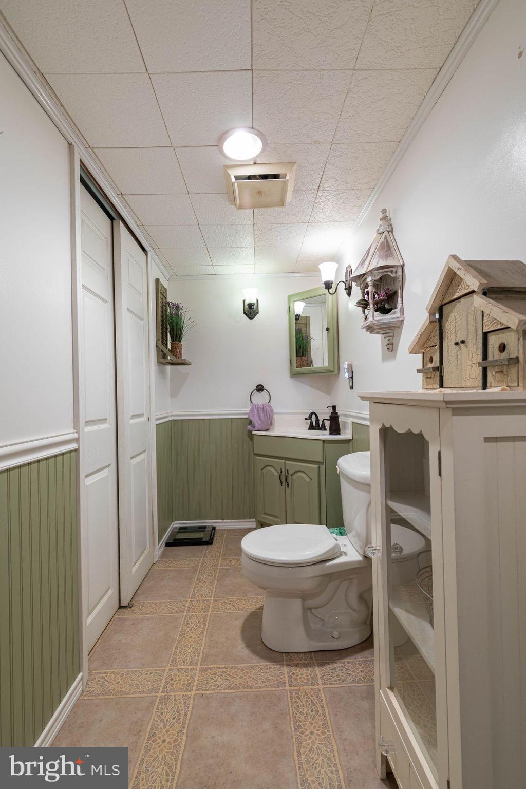 1239 Landover Road Baltimore, MD 21237 - Photo 13 of 13 a bathroom with a sink a toilet a mirror and vanity