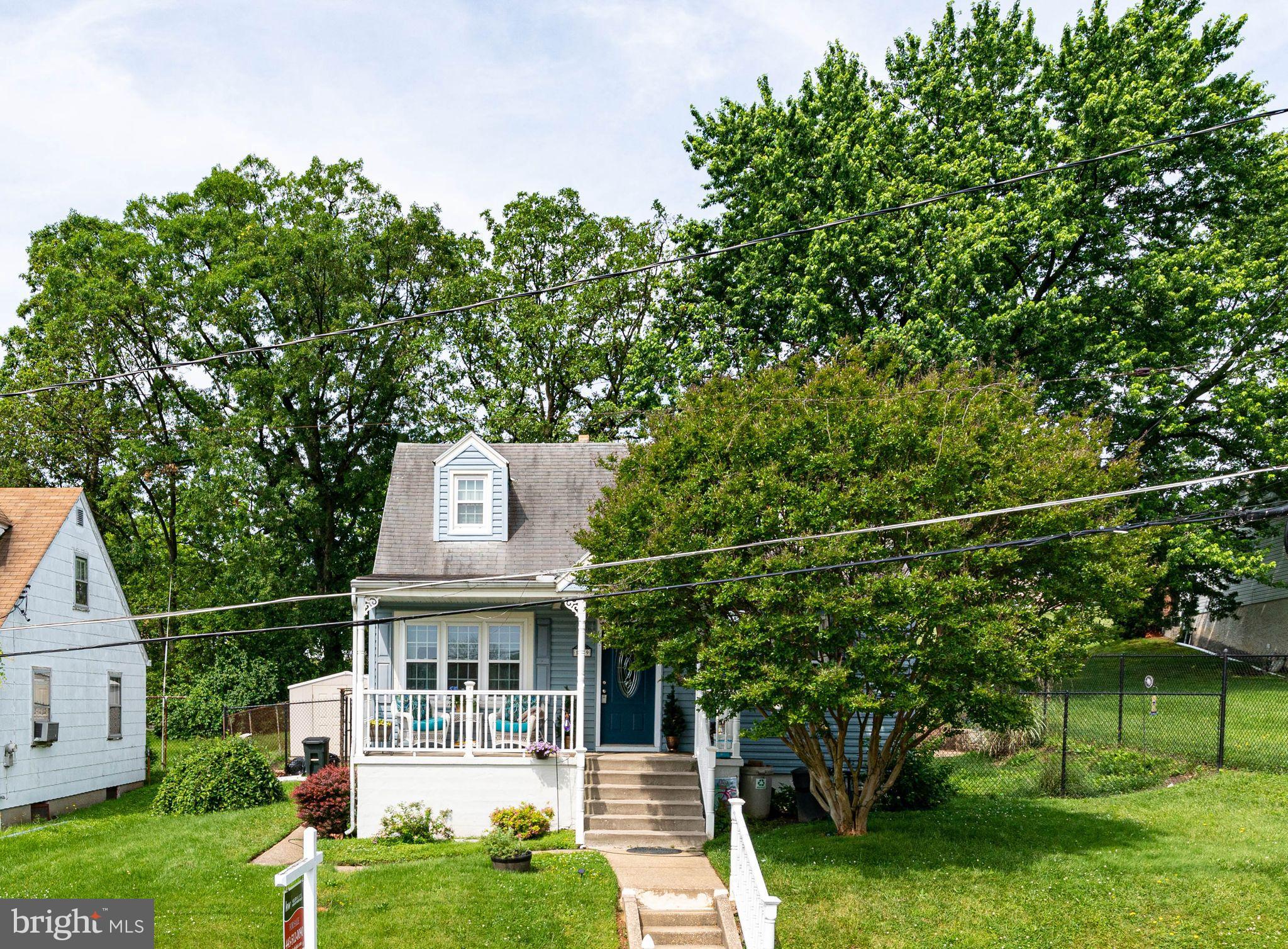 1239 Landover Road Baltimore, MD 21237 - Photo 3 of 13 a front view of a house with a garden