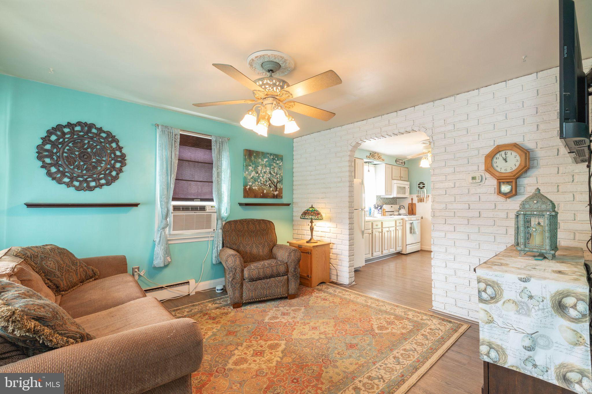 1239 Landover Road Baltimore, MD 21237 - Photo 5 of 13 a living room with furniture and wooden floor