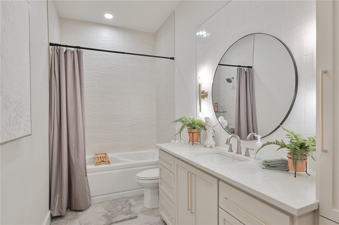 10704 Harvey Ranch Road College Station, TX 77845 - Photo 16 of 18 a bathroom with a granite countertop sink a toilet and a mirror