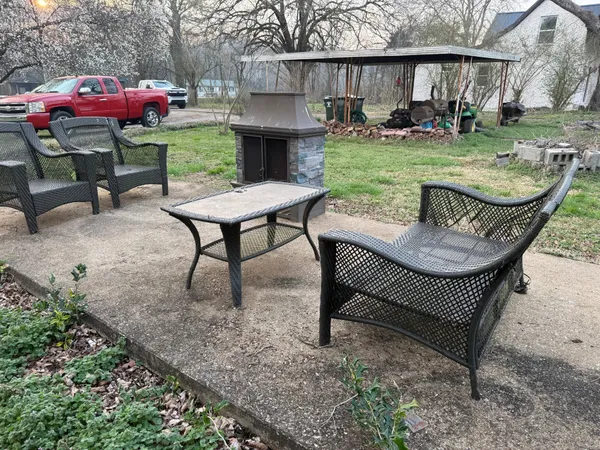 a view of a backyard with sitting area furniture and garden