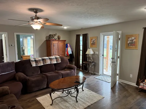 a living room with furniture and a chandelier