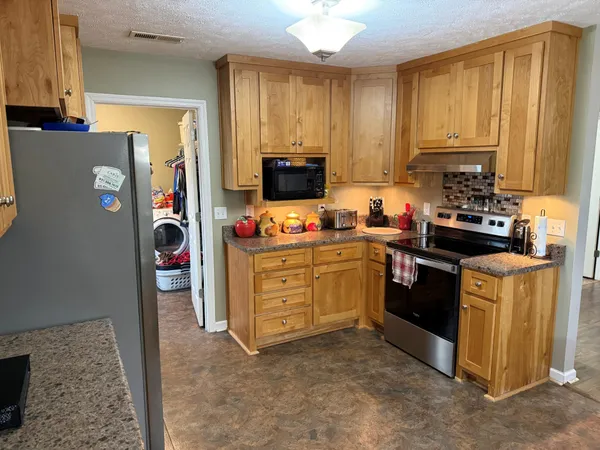 a kitchen with a refrigerator stove and sink