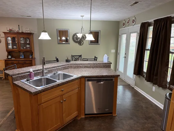 a kitchen with sink a counter space and stainless steel appliances