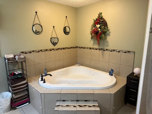 a bathroom with a bathtub and mirror