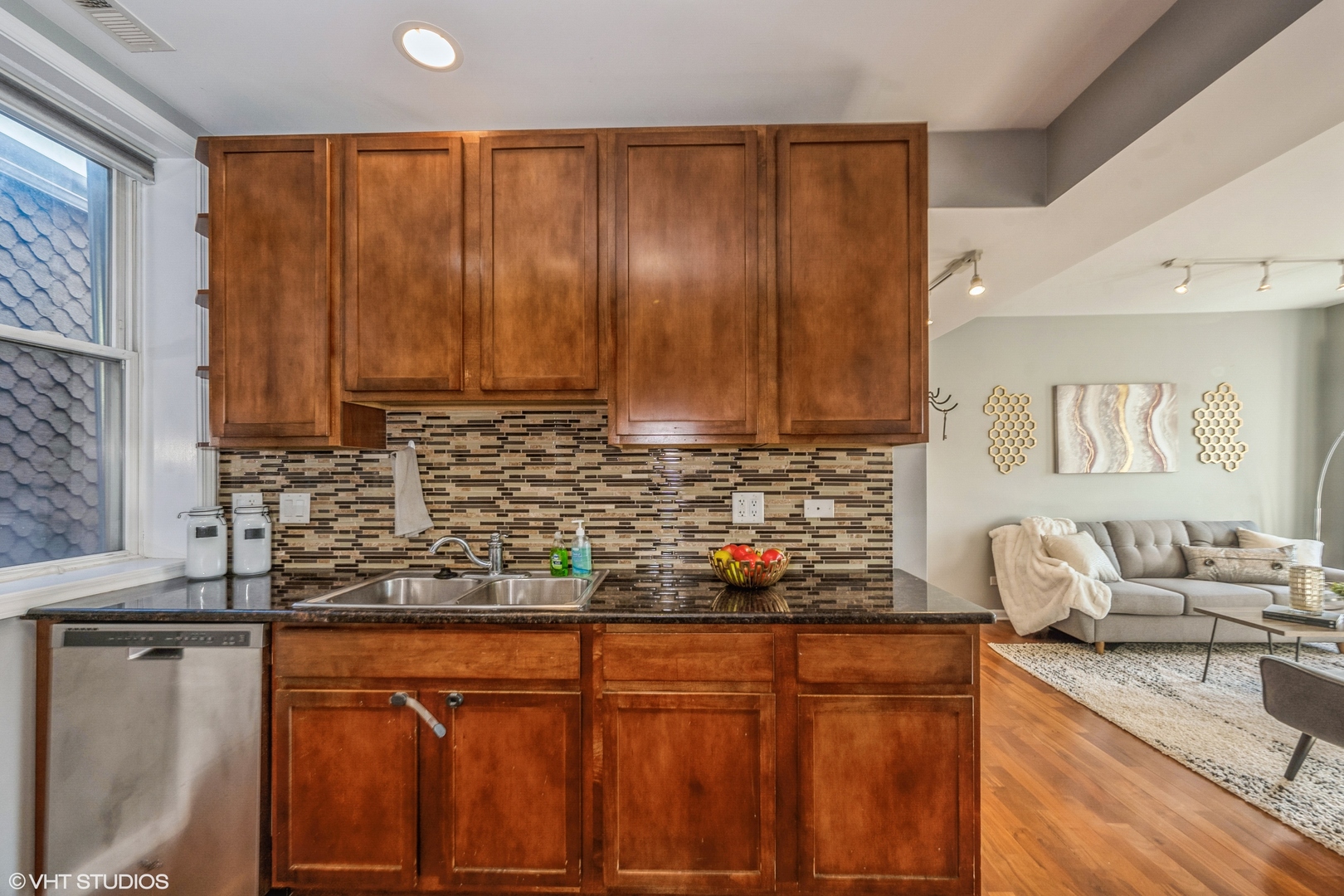 1750 West Rascher Avenue, Unit 2 Chicago, IL 60640 - Photo 6 of 11 a kitchen with stainless steel appliances granite countertop wooden cabinets a sink and dishwasher